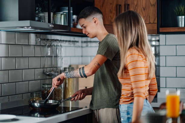 istock Lesbian couple cooking together in modern kitchen 2200180532