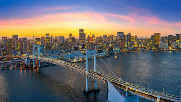 istock Rainbow bridge and Tokyo cityscape at sunset, Japan. 2200181538