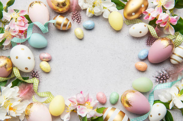 istock Easter eggs frame forming a circle on a gray background with flowers and feathers 2200181830