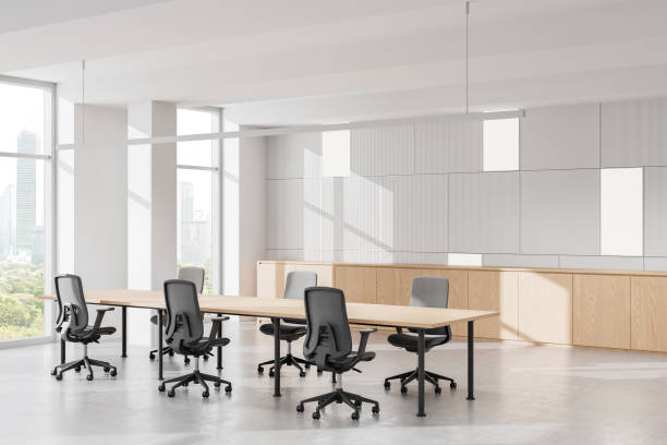 istock Modern open-space office interior with large windows, cityscape view, and rows of desks and chairs. 3D Rendering 2200182188