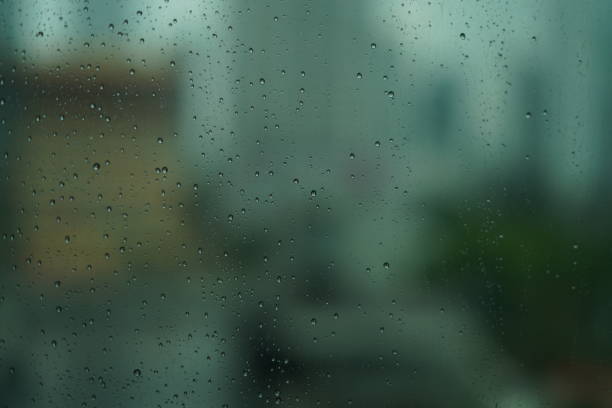 Rainy day, water drops in window with dark evening time, 4K Video