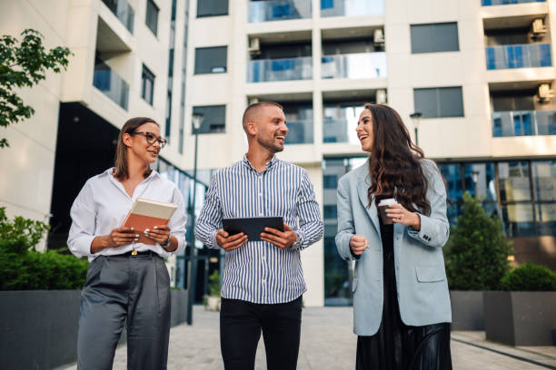 istock Three business people walking and talking in the city 2200182373