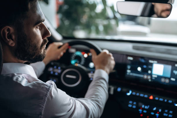 istock View from behind. Man is sitting in car, detailed view 2200184841