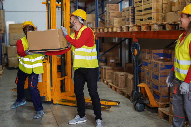 istock Warehouse working people move boxes - Industrial occupation concept - Focus on center man face 2200185407
