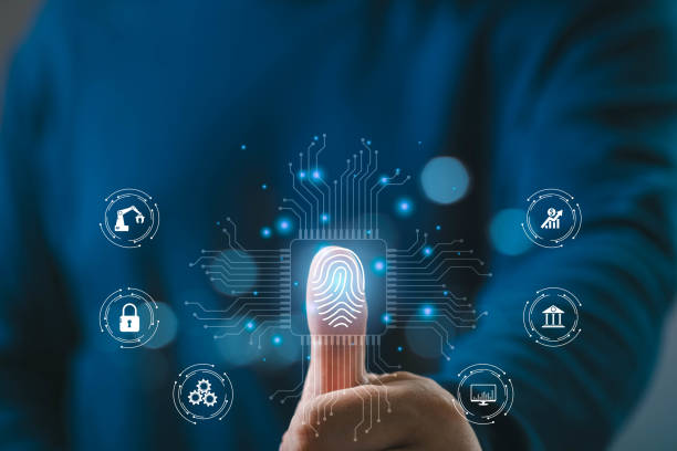 istock Close-up of a person's thumb using digital fingerprint scanning technology, surrounded by futuristic virtual icons on a dark background. 2200186283