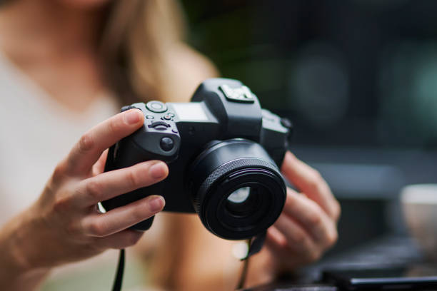 A young girl taking a selfie with a camera