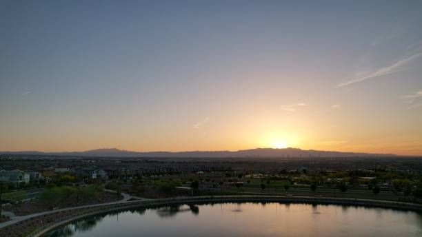 istock Sunset over suburban lake and mountains. 2200188561