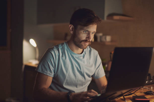 istock Remote work, night and man with laptop, online reading and connection with creative project. Copywriting, evening and freelancer with pc, research for article and editor with proposal, home or review 2200189025