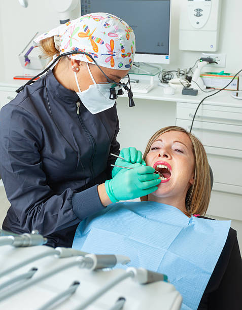 istock Dentist examining patient's teeth in dental clinic 2200190215