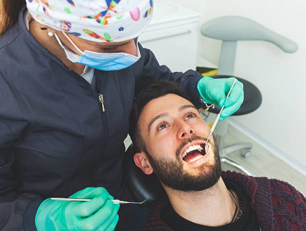 istock Dentist examining patient's teeth in dental clinic 2200190242
