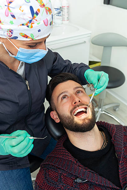 istock Dentist examining patient's teeth in dental clinic 2200190246