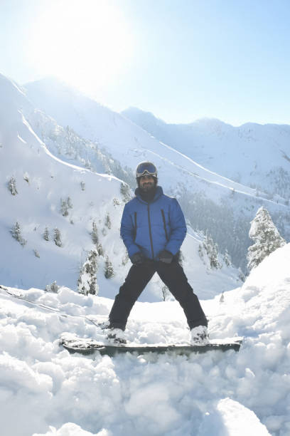 istock Male snowboarder on snowy hill 2200190638