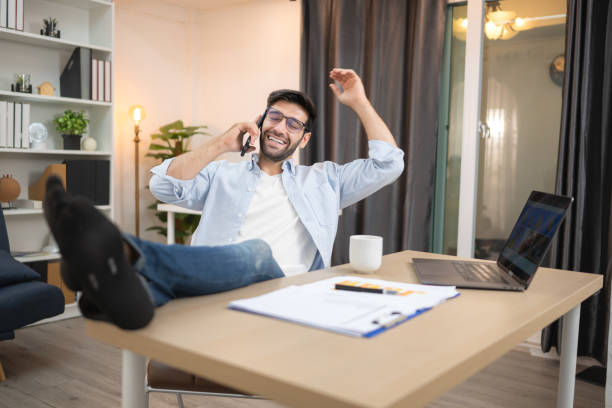 istock young freelancer smiling while working online via laptop at home 2200191190