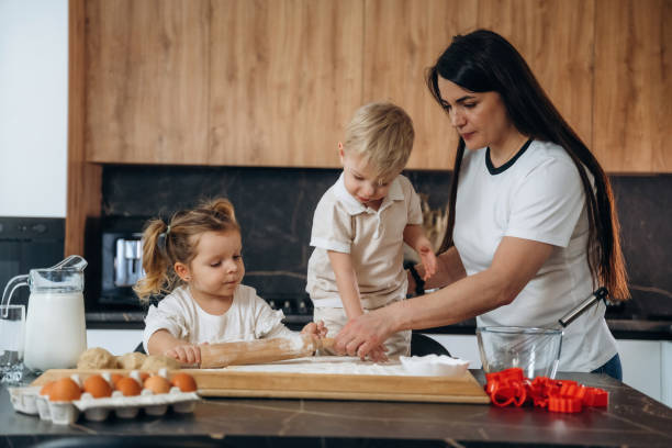 istock Mother with son and daughter are preparing bakery at home 2200191479