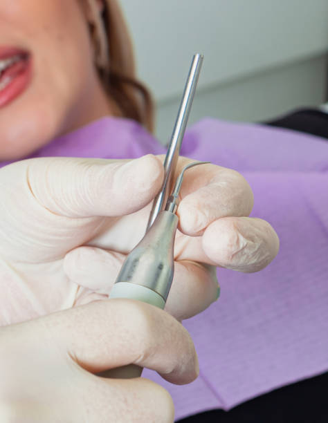 istock Dentist holding dental equipment preparing for teeth cleaning 2200191559