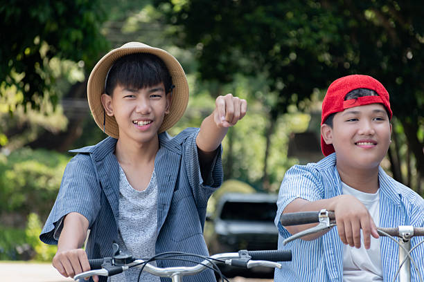 istock Boys riding bicycles in the park. 2200194418