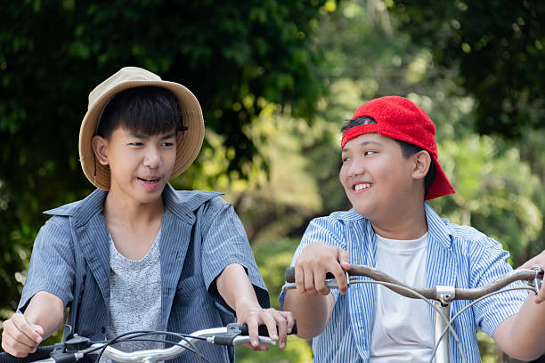istock Boys riding bicycles in the park. 2200194497
