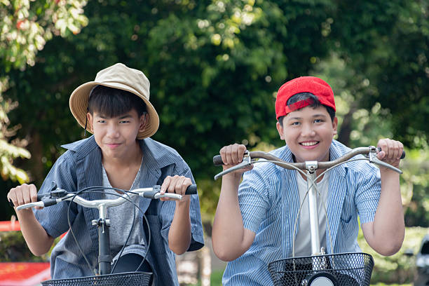istock Boys riding bicycles in the park. 2200194571