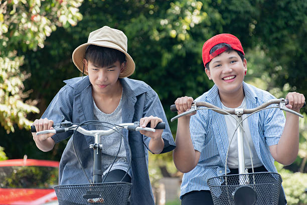 istock Boys riding bicycles in the park. 2200194579