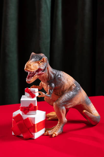 istock Cute dinosaur with present boxes on red and green background 2200195007
