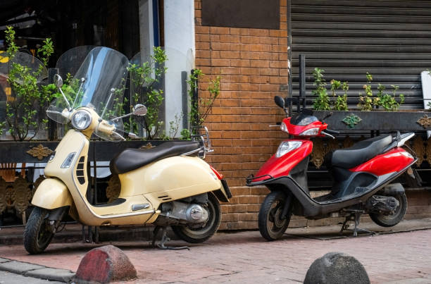 istock Two scooters parked on old street 2200195136