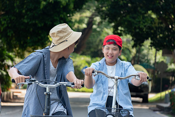 istock Boys riding bicycles in the park. 2200195490