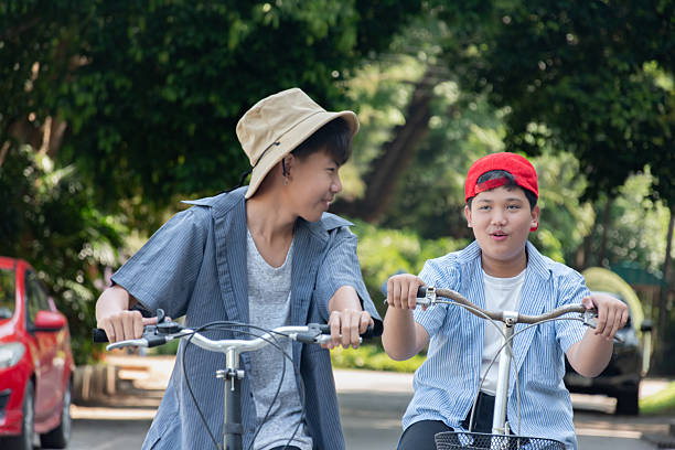 istock Boys riding bicycles in the park. 2200195504
