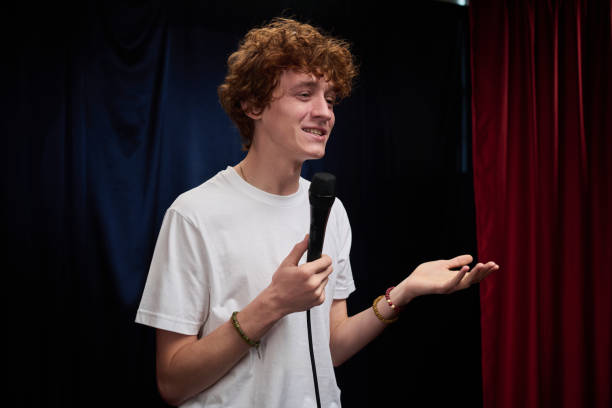 istock Young Man Performing Stand-Up Comedy on Stage 2200195929