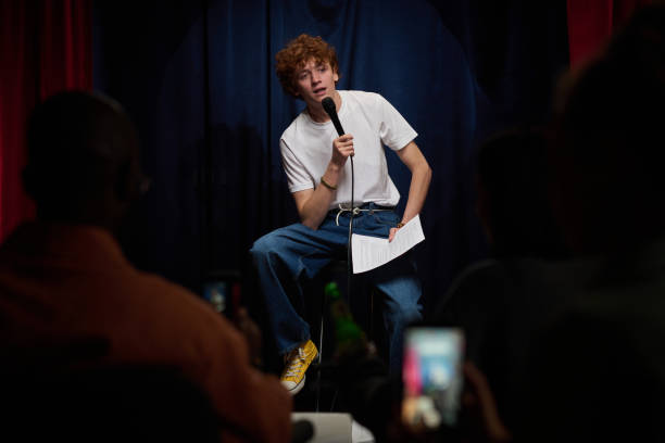 istock Performing Stand-Up Comedy on Stage Holding Microphone 2200195931