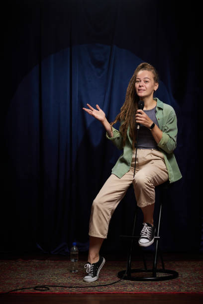 istock Young Woman Performing Standup Comedy On Stage 2200195942