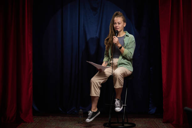 istock Young Woman Delivering Stand-Up Comedy Routine on Stage 2200195948
