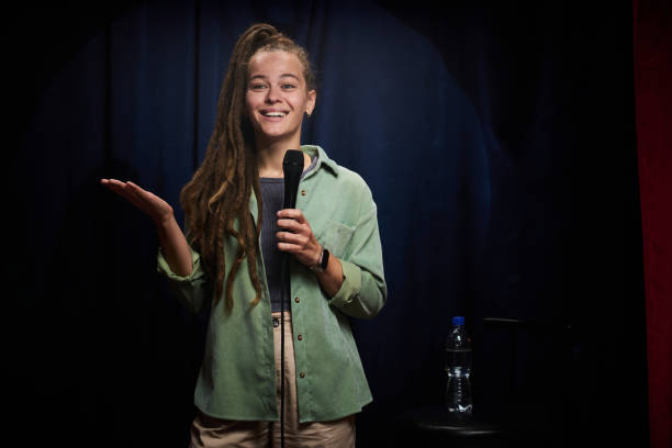 istock Smiling Woman Performing Stand-Up Comedy on Stage 2200195968