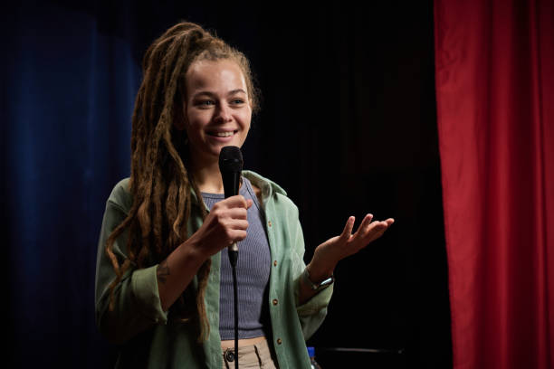 istock Smiling Woman with Dreadlocks Performing stand-up comedy 2200195977