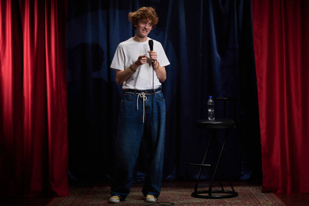 istock Performing Standup Comedy on Stage in Front of Red Curtains 2200195980