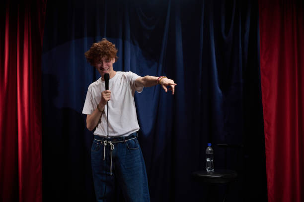 istock Performing Stand-up Comedy with Microphone on Dark Stage 2200195981