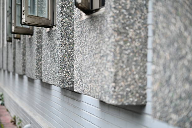 A textured terrazzo-framed window set on a clean white brick wall, highlighting a blend of Japanese and modern minimalist design. The uniform row of glass windows enhances the structural harmony.