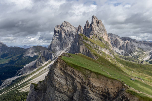 istock Seceda Ridge in the Dolomites, showcasing its iconic meadow, rugged cliffs, and hikers exploring the picturesque mountain trails 2200197078