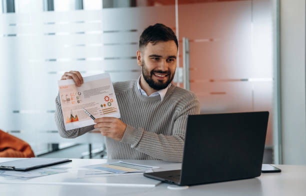 istock Businessman is sitting by table in office 2200197422