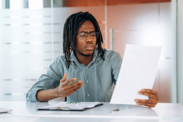 istock Sad and tired. Black businessman is working in office 2200197461