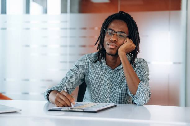 istock Sad and tired. Black businessman is working in office 2200197518