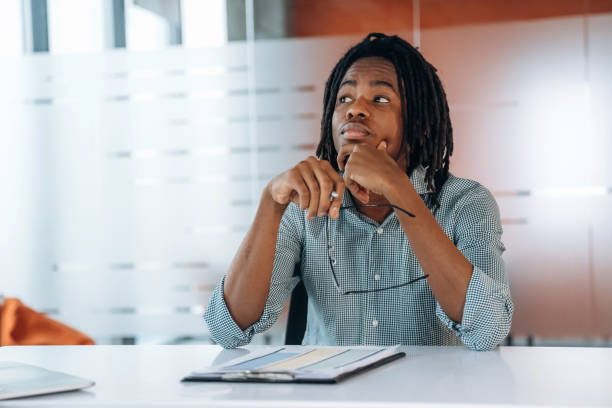 istock Front view, sitting. Black businessman is working in office 2200197523