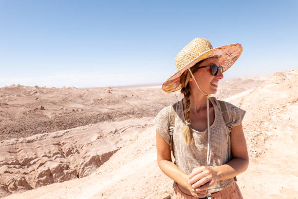 istock Woman Exploring Desert Landscape in Straw Hat 2200197746