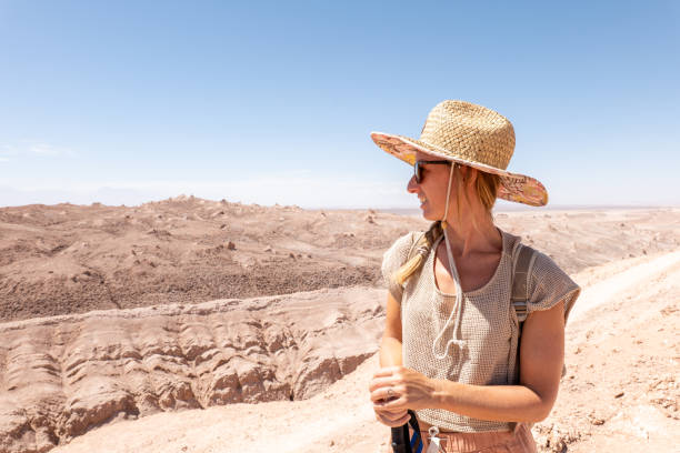 istock Woman Exploring Desert Landscape in Straw Hat 2200197847