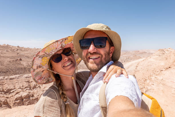 istock Smiling Couple Taking a Selfie on a Sunny Desert Adventure 2200197913