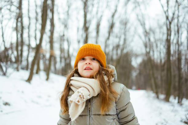 istock Girl Enjoying a Winter Day in the Forest 2200198215