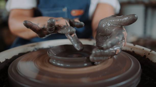 Artisan Molding Clay into a Handmade Cup on a Spinning Pottery Wheel