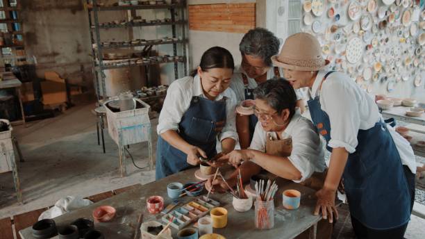 istock Happy Elderly Friends Celebrating Their Ceramic Artwork with a Selfie 2200199782