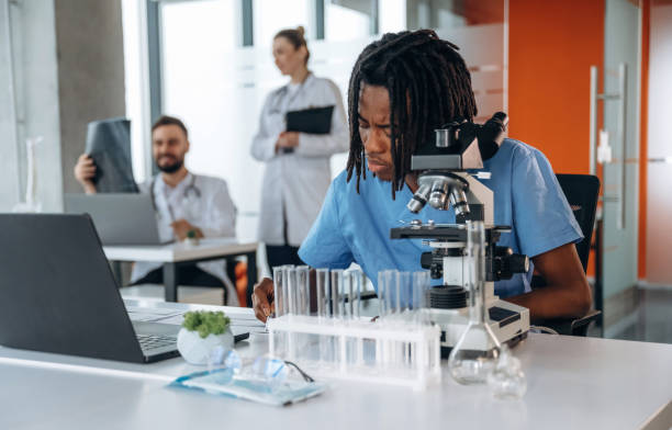 istock Professional microscope is on the table. Doctors are in the clinic 2200199998
