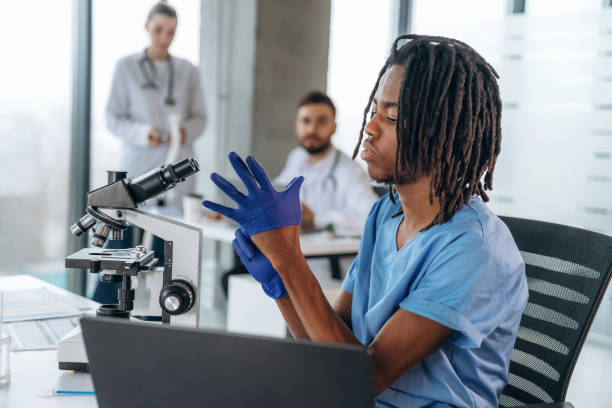 istock Scientific research by using microscope. Doctors are in the clinic 2200200069
