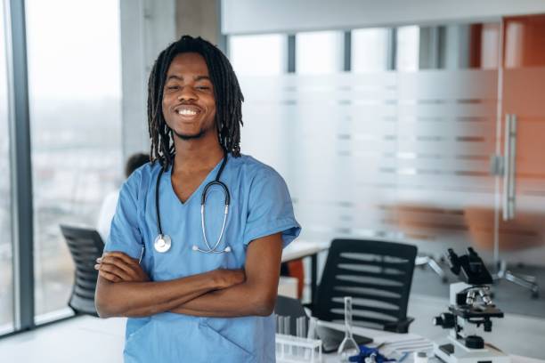 istock Standing and smiling. Black man doctor is in the office 2200200364